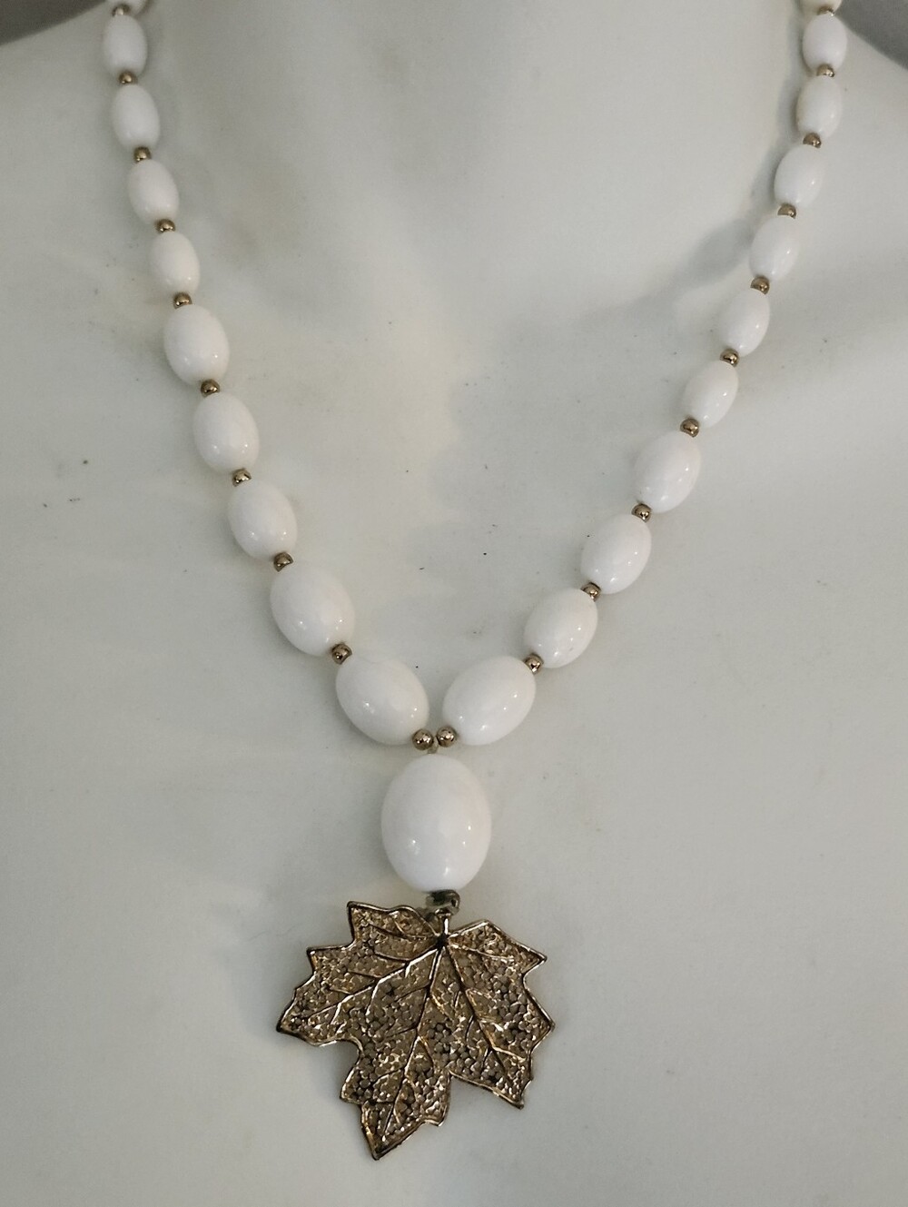 White Beaded Necklace with Gold Tone Textured Leaf Pendant - 18 Inches